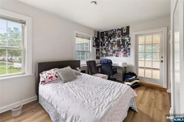 a bedroom with bed window and a potted plant