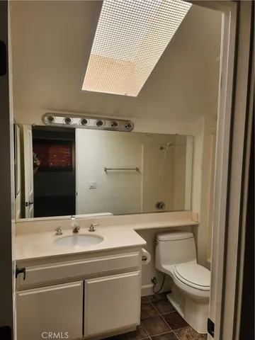 a bathroom with a sink a toilet and mirror