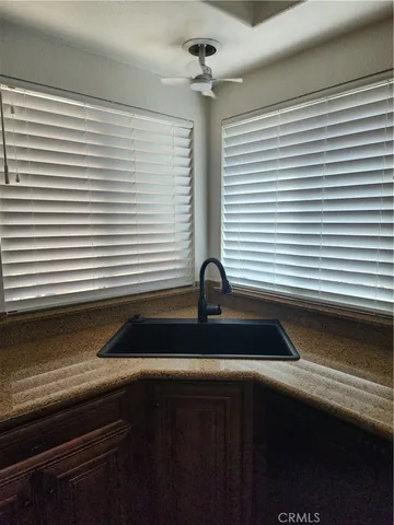 a kitchen with a sink and wooden floor