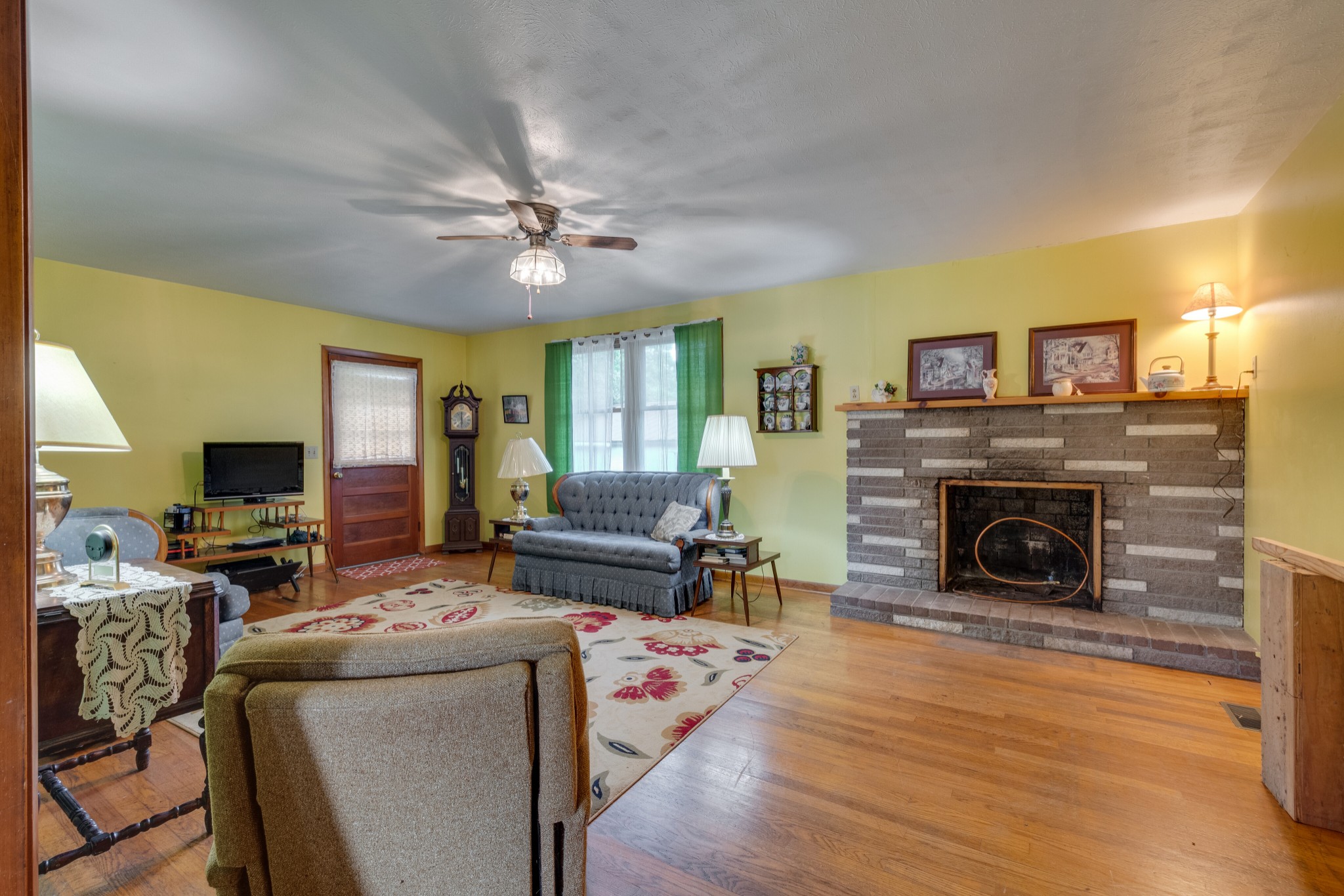 7795 Pewitt Road Franklin, TN 37064 - Photo 4 of 20 a living room with furniture a fireplace and a flat screen tv