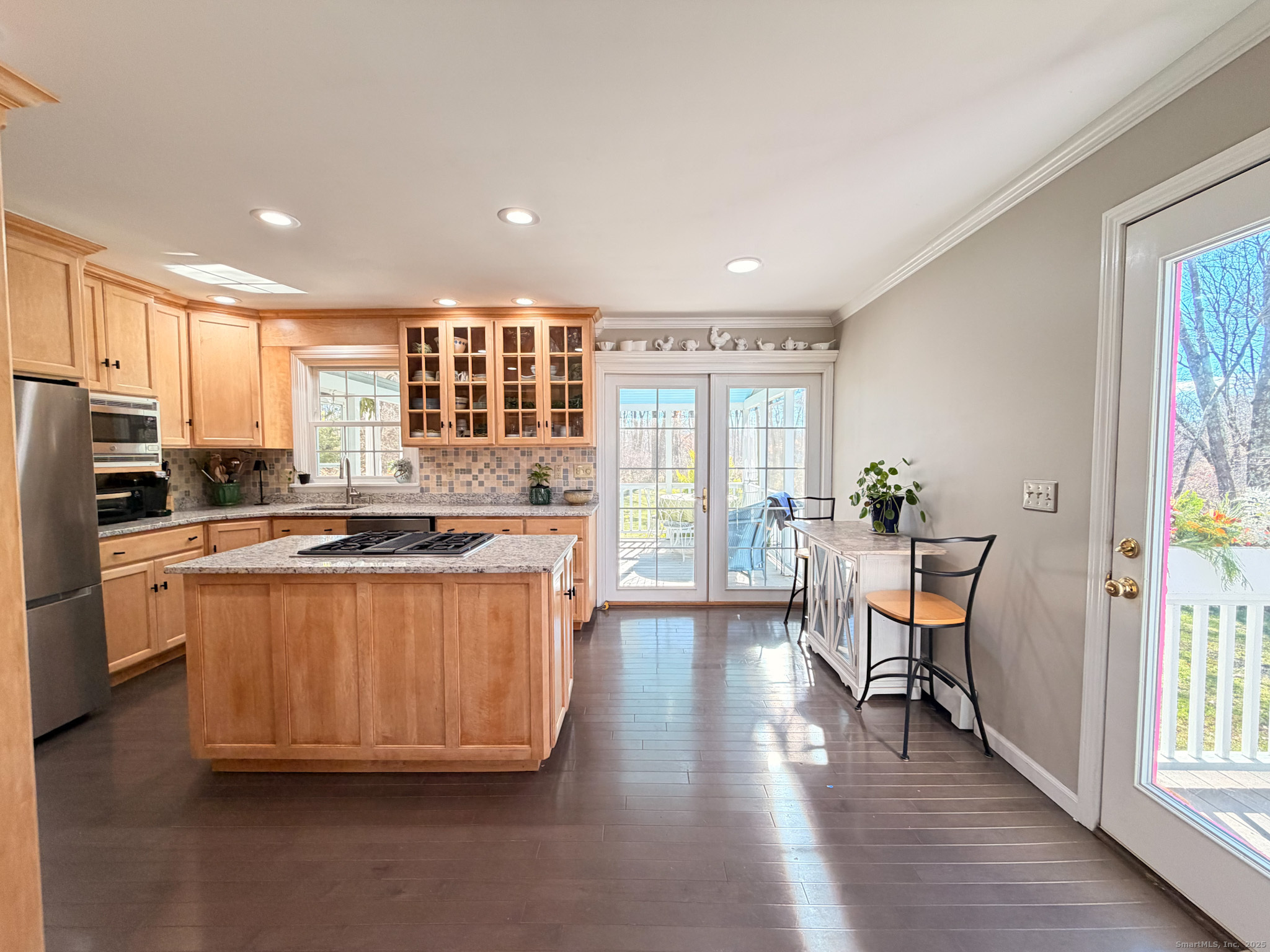 104 Pulpit Rock Road Woodstock, CT 06281 - Photo 14 of 37 a kitchen with stainless steel appliances granite countertop wooden floors and white cabinets