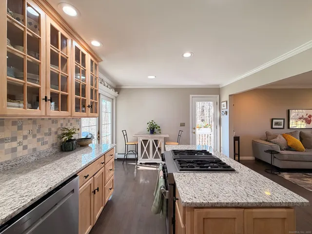 a kitchen with sink stove and cabinets