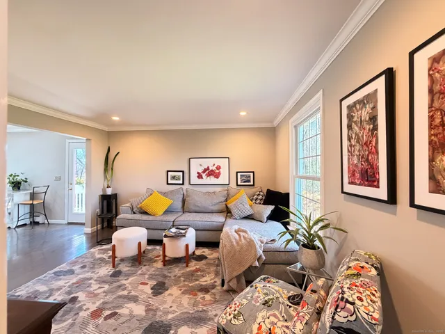 a living room with furniture a rug and a window