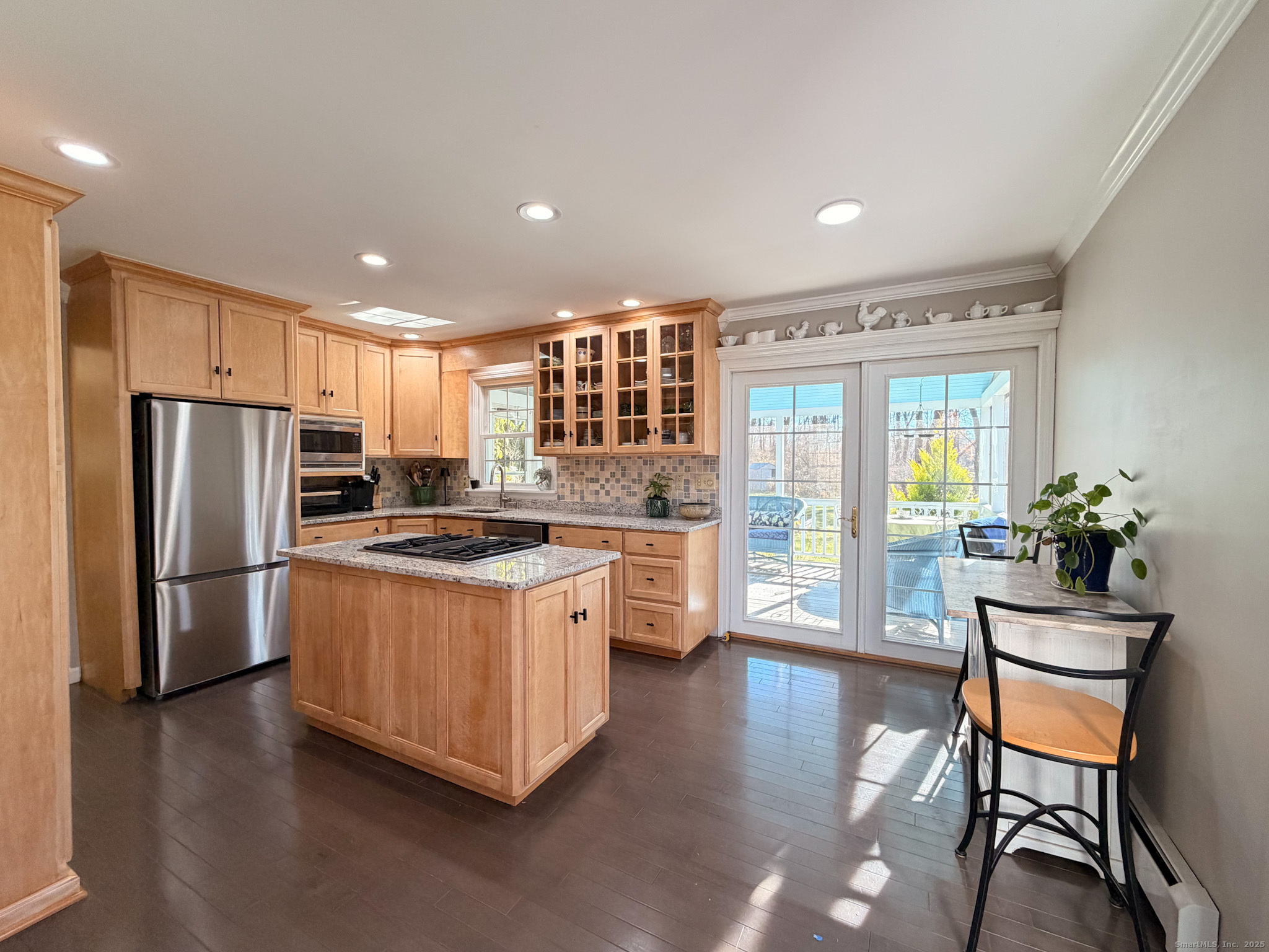 104 Pulpit Rock Road Woodstock, CT 06281 - Photo 9 of 37 a kitchen with stainless steel appliances granite countertop a stove a refrigerator a kitchen island a dining table and chairs