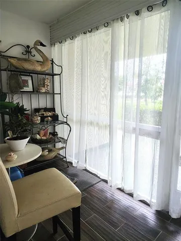 a view of a dining room with furniture and window