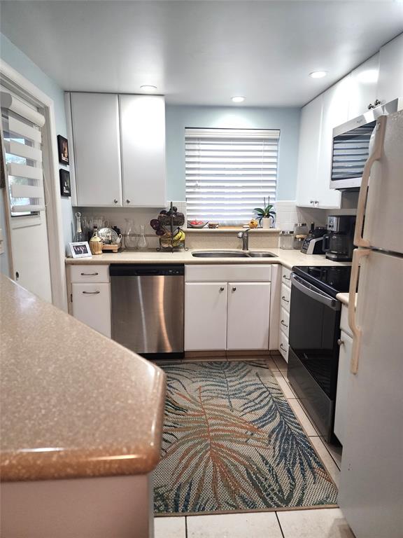 804 Southeast 7th Street, Unit 101 Deerfield Beach, FL 33441 - Photo 5 of 14 a kitchen with granite countertop a sink stainless steel appliances and cabinets