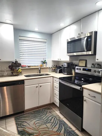 a kitchen with a sink stove and microwave