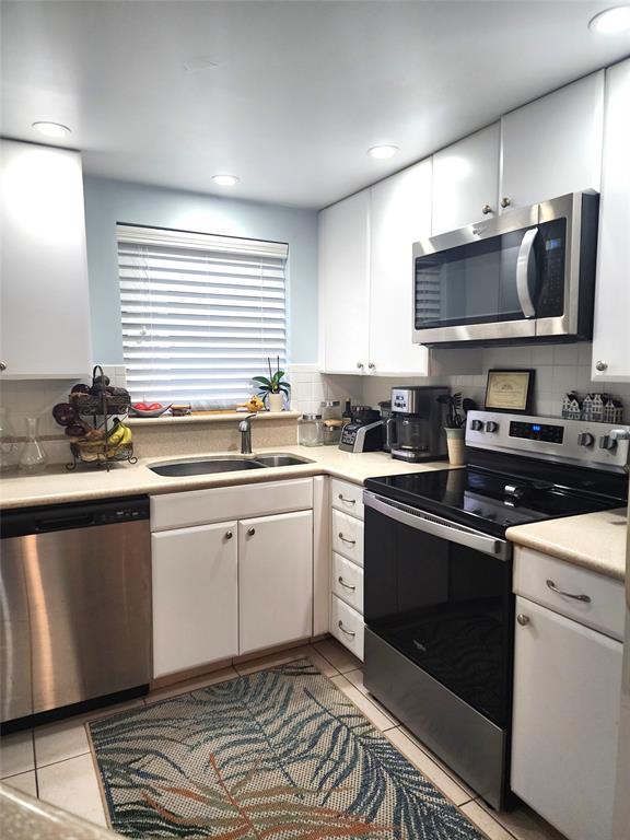 804 Southeast 7th Street, Unit 101 Deerfield Beach, FL 33441 - Photo 7 of 14 a kitchen with a sink stove and microwave