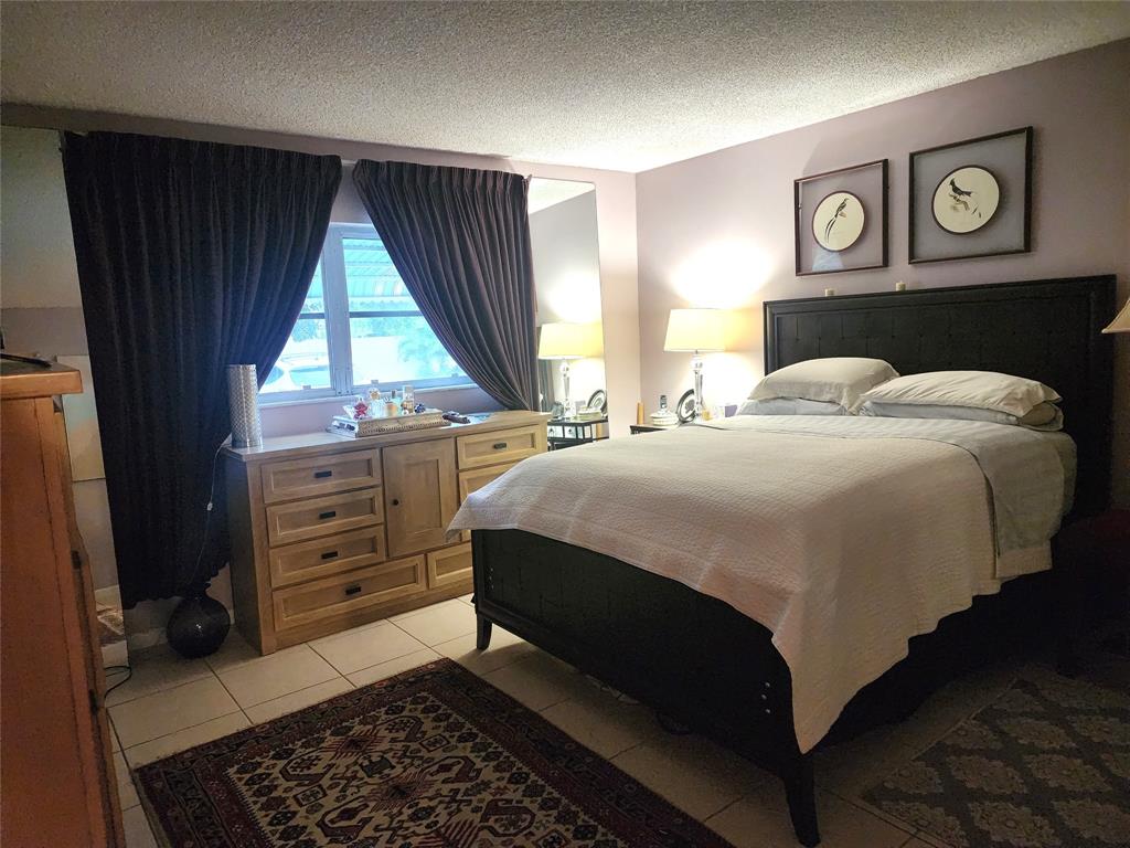 804 Southeast 7th Street, Unit 101 Deerfield Beach, FL 33441 - Photo 9 of 14 a bedroom with a bed and a window