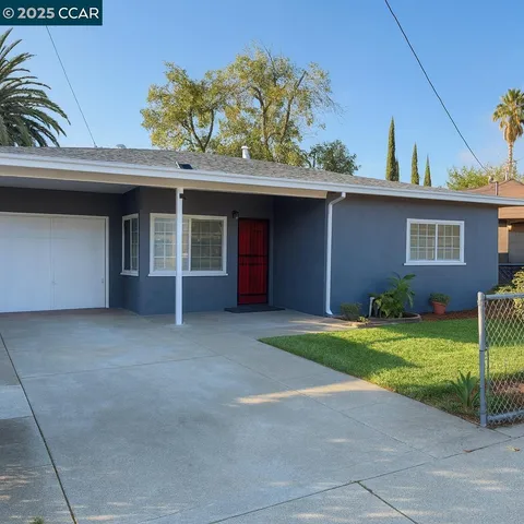 a view of a house with a yard and garage