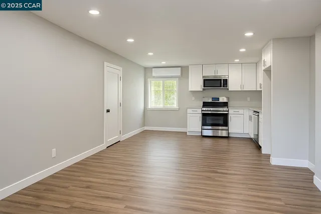 a view of kitchen with microwave and cabinets