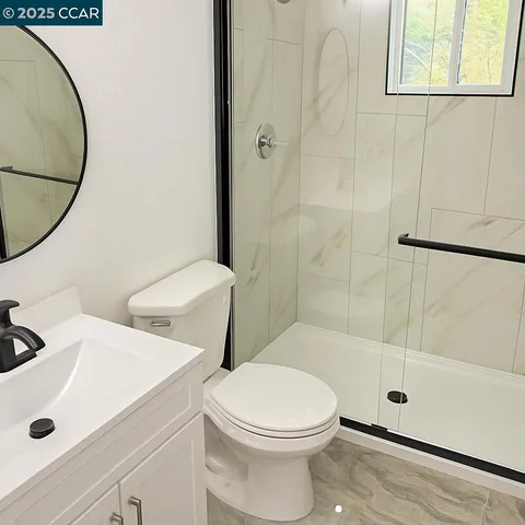 a white toilet sitting next to a bathroom sink