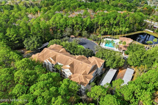 an aerial view of house with yard and outdoor seating