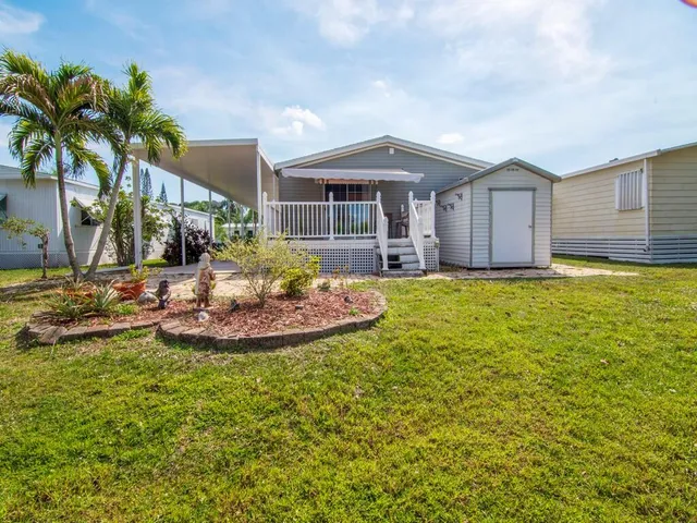 a view of a house with swimming pool and a yard