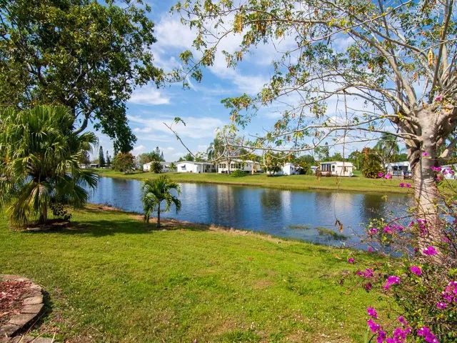 a view of a lake with a house in the background