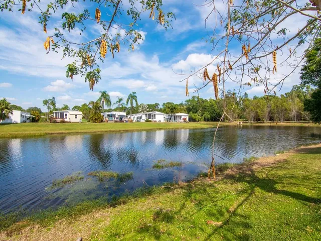 a view of a lake with a house in the background