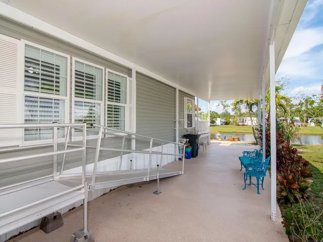 a swimming pool with outdoor seating and yard