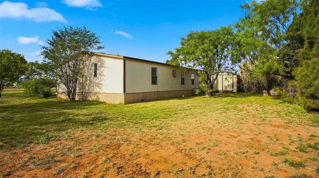 10902 County Road 414 Merkel, TX 79536 - Photo 5 of 26 a view of a yard with potted plants and large trees