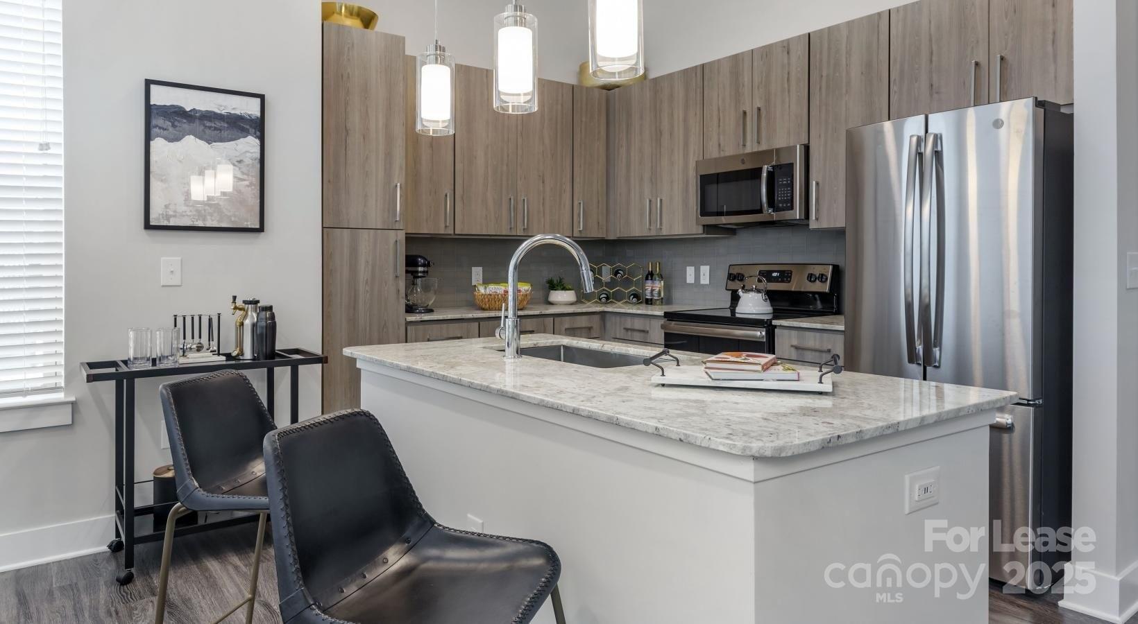 6805 Walnut Branch Lane, Unit 222 Charlotte, NC 28277 - Photo 6 of 22 a kitchen with granite countertop a sink cabinets and stainless steel appliances