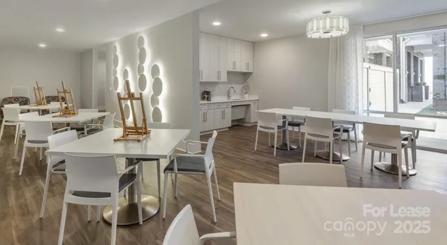 a living room with stainless steel appliances kitchen island granite countertop furniture and a dining table