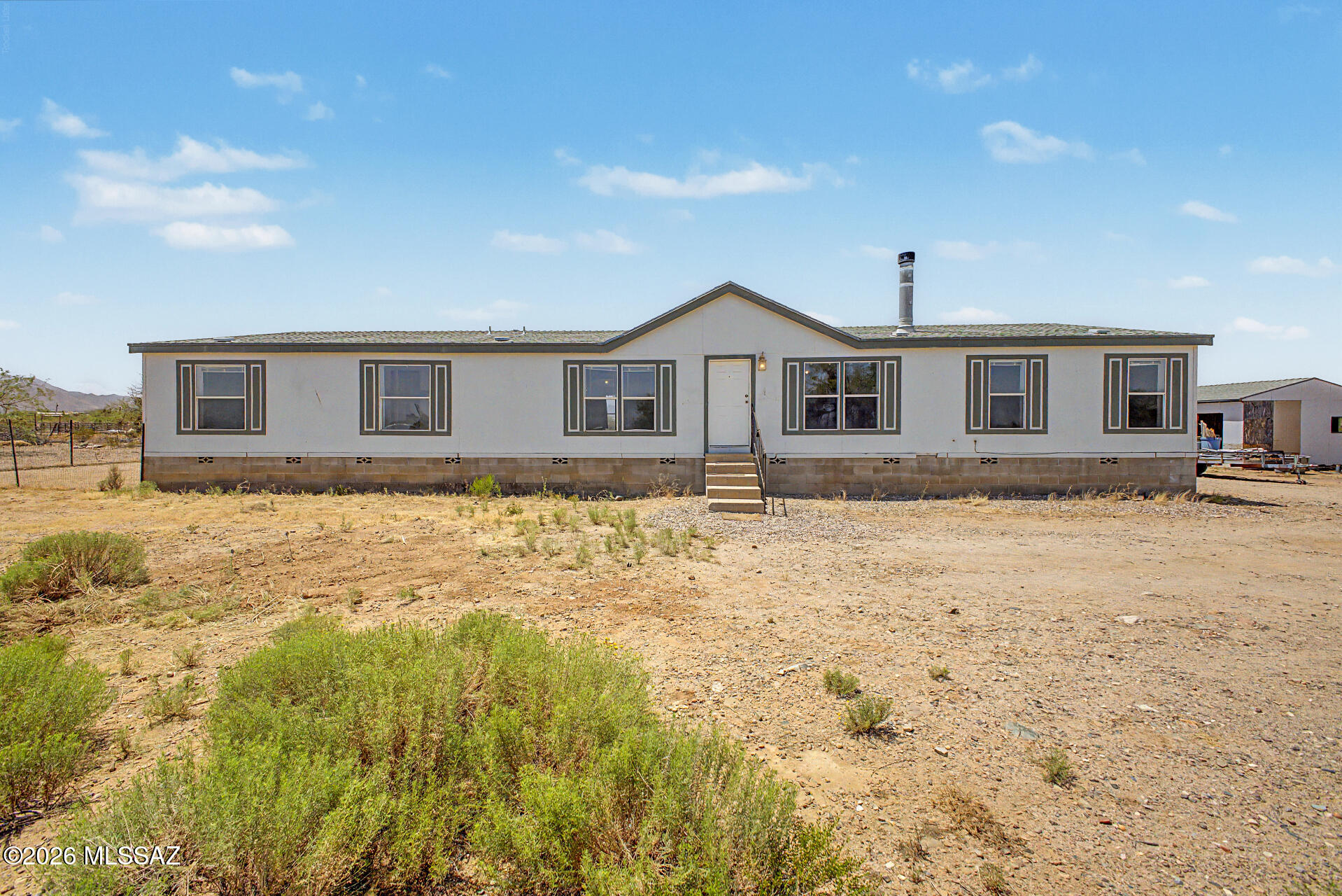 1911 West Thunder Road Vail, AZ 85641 - Photo 1 of 38 a front view of house with yard and trees in the background