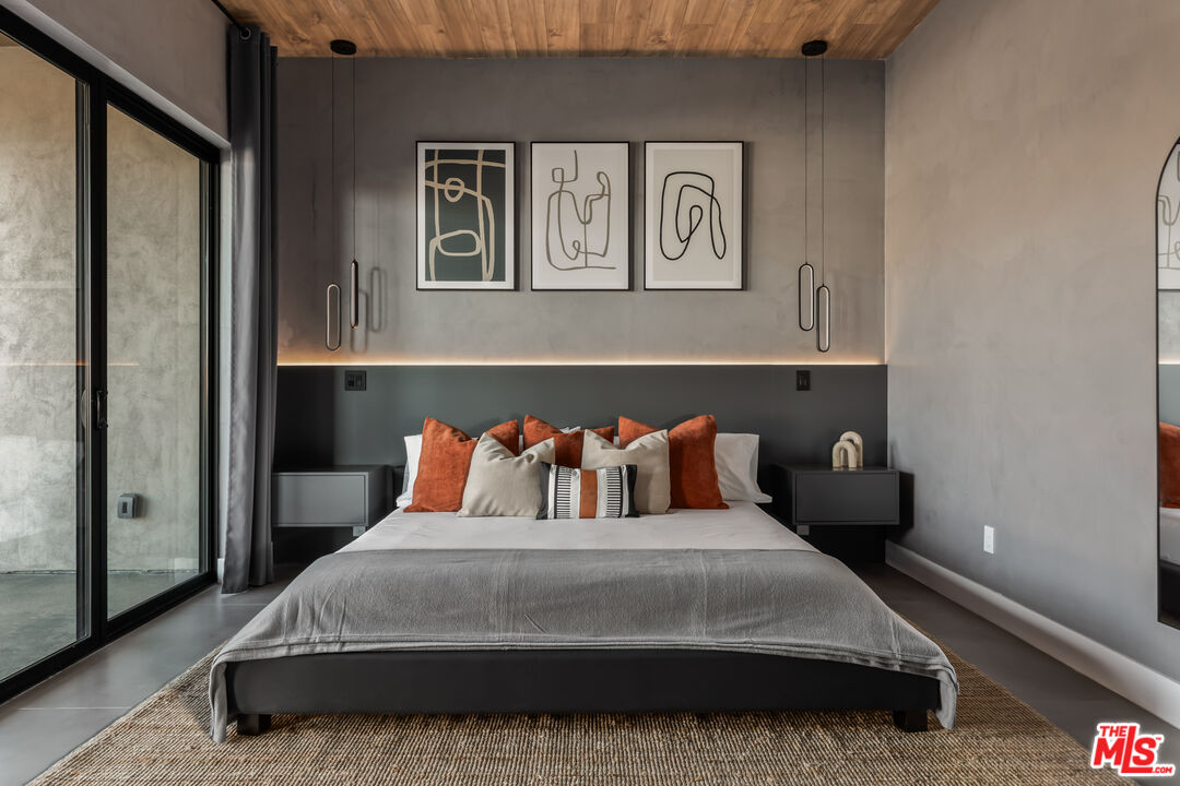 6765 Swanson Road Joshua Tree, CA 92252 - Photo 23 of 69 a bedroom with a large bed and a painting on the wall