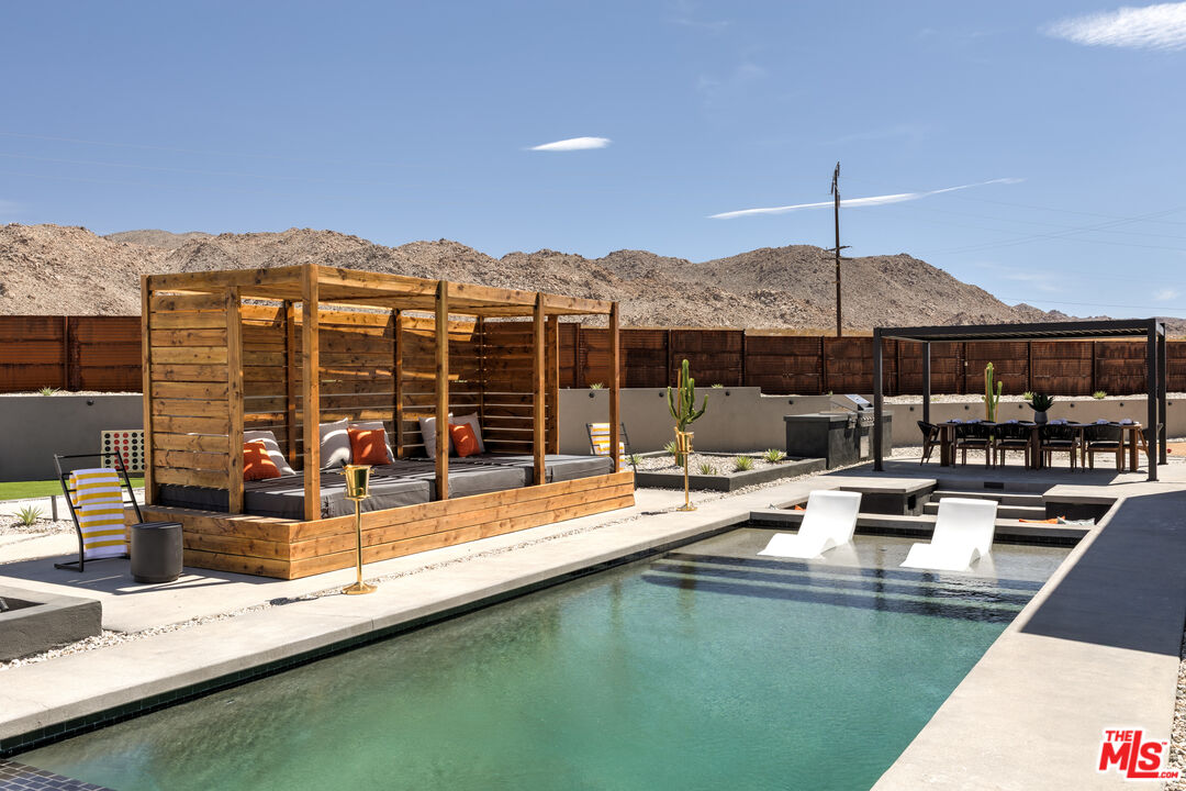 6765 Swanson Road Joshua Tree, CA 92252 - Photo 39 of 69 a view of a swimming pool with a patio