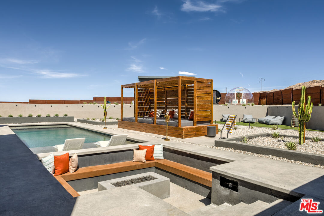 6765 Swanson Road Joshua Tree, CA 92252 - Photo 41 of 69 a view of swimming pool with outdoor seating
