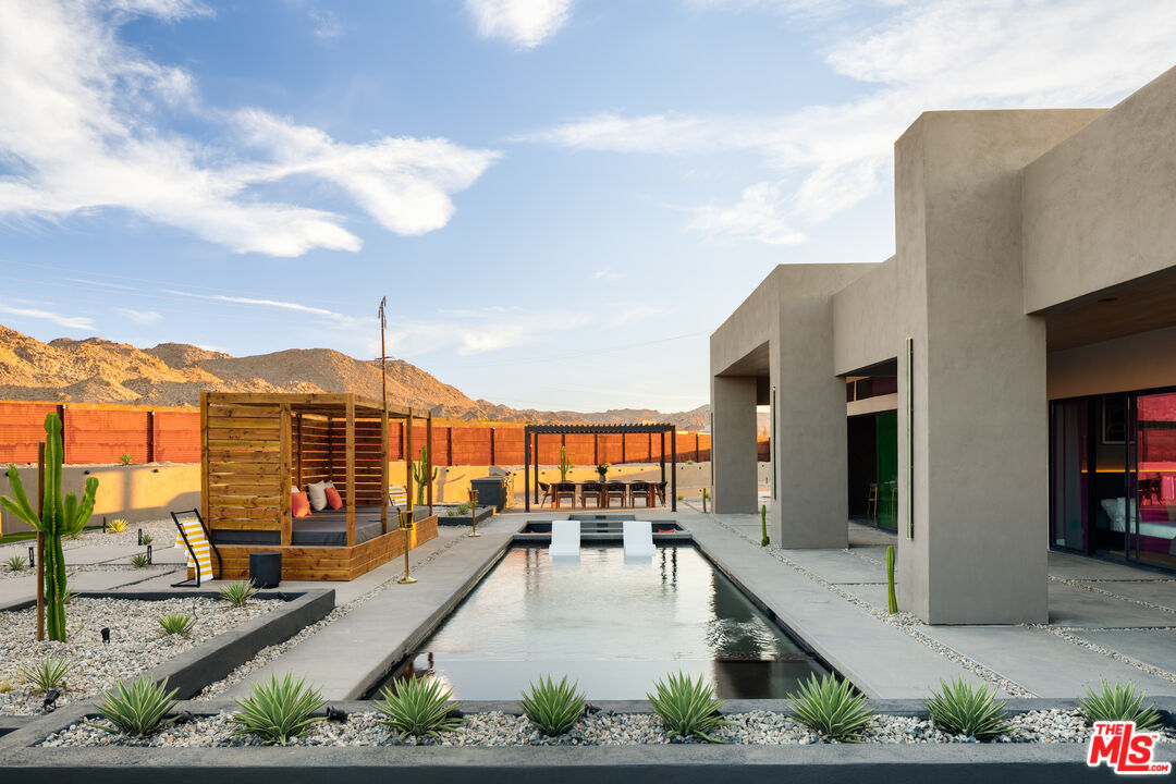 6765 Swanson Road Joshua Tree, CA 92252 - Photo 42 of 69 a view of a swimming pool with a lounge chair