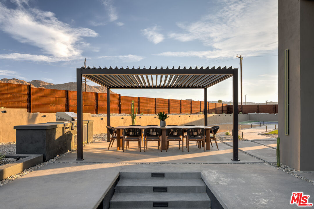 6765 Swanson Road Joshua Tree, CA 92252 - Photo 46 of 69 a view of a swimming pool with a table and chairs