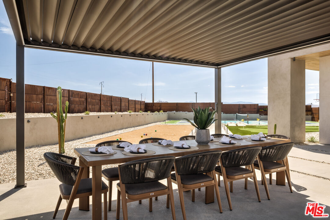 6765 Swanson Road Joshua Tree, CA 92252 - Photo 47 of 69 a view of an outside dining space with furniture