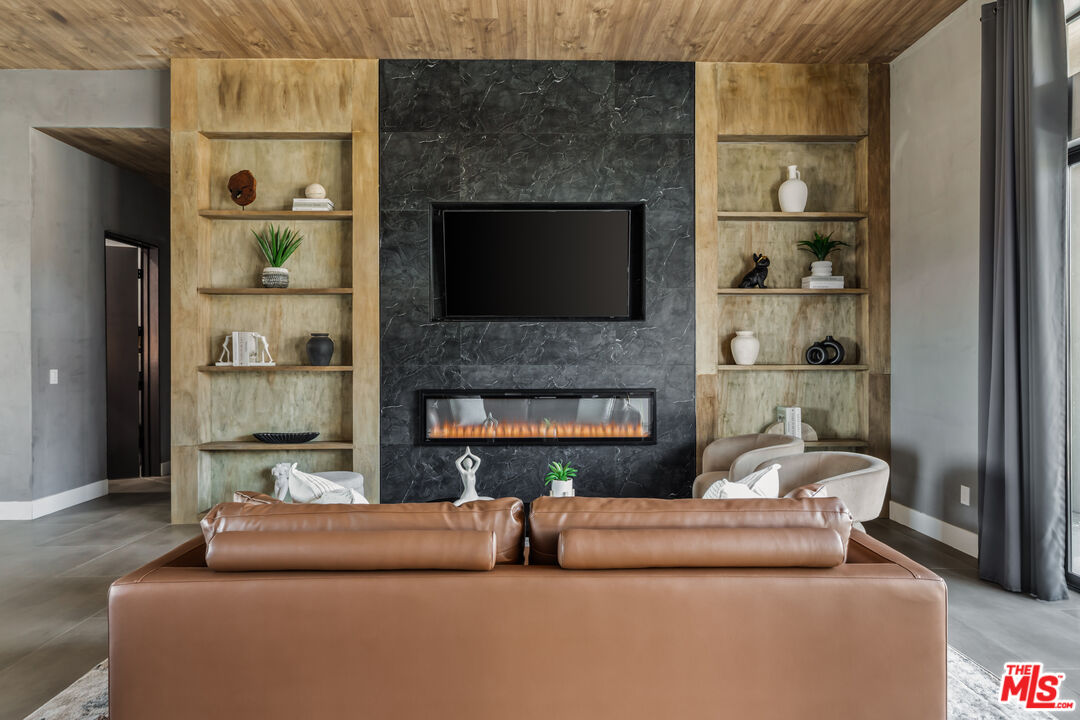 6765 Swanson Road Joshua Tree, CA 92252 - Photo 8 of 69 a living room with furniture and a fireplace