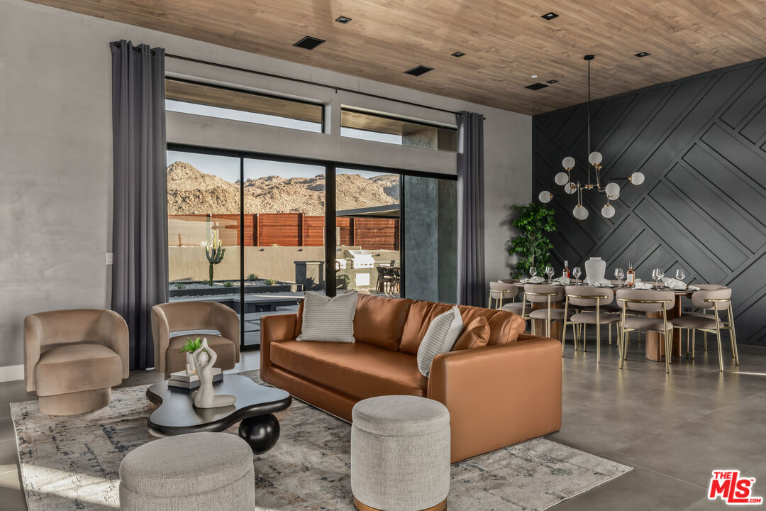 6765 Swanson Road Joshua Tree, CA 92252 - Photo 10 of 69 a living room with furniture and a large window