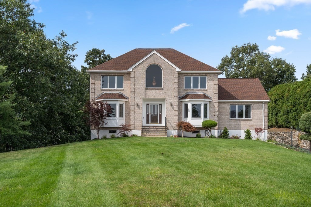 a front view of a house with a garden