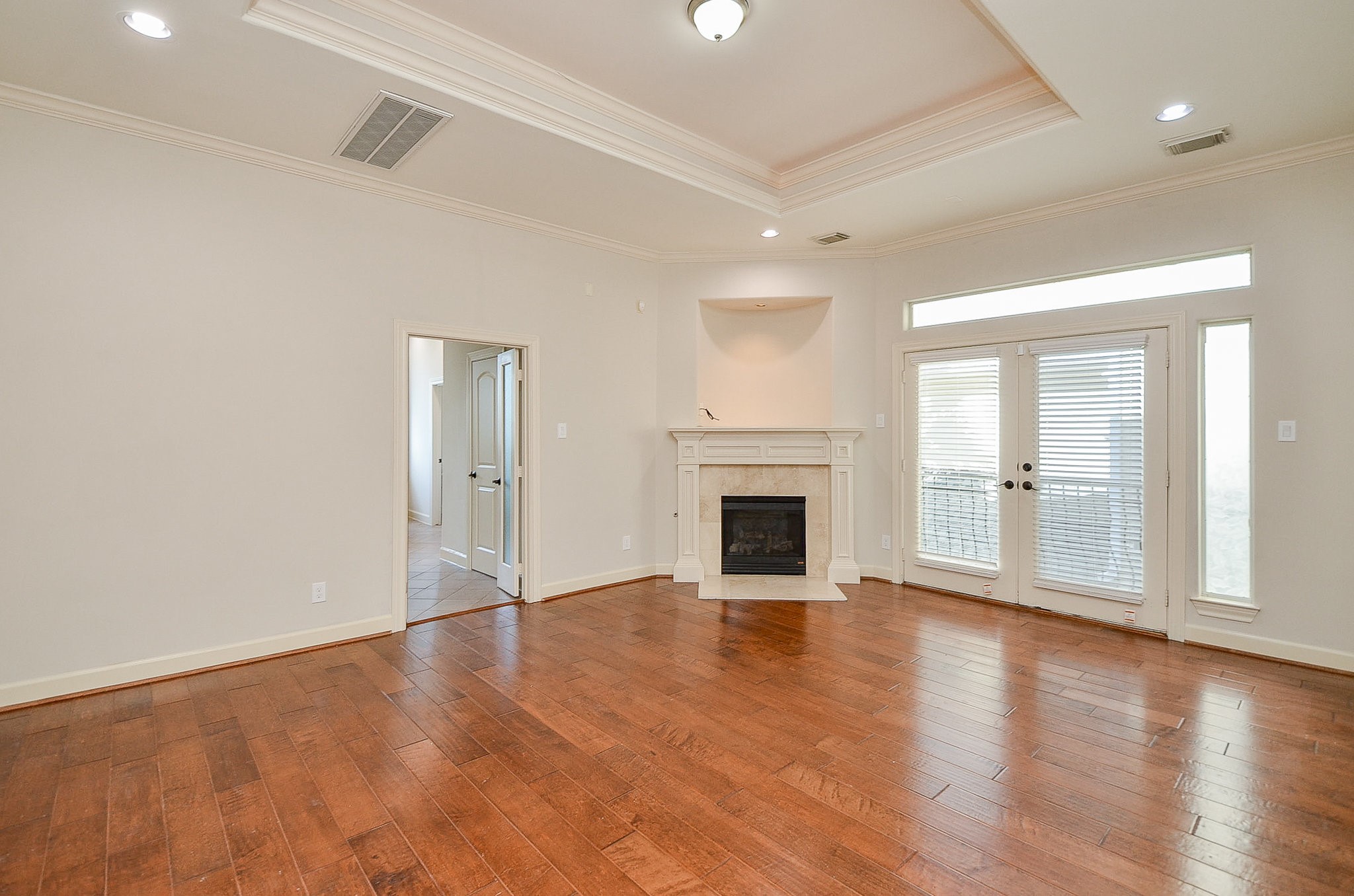 5512 Hidalgo Street Houston, TX 77056 - Photo 19 of 32 a view of empty room with wooden floor and fireplace