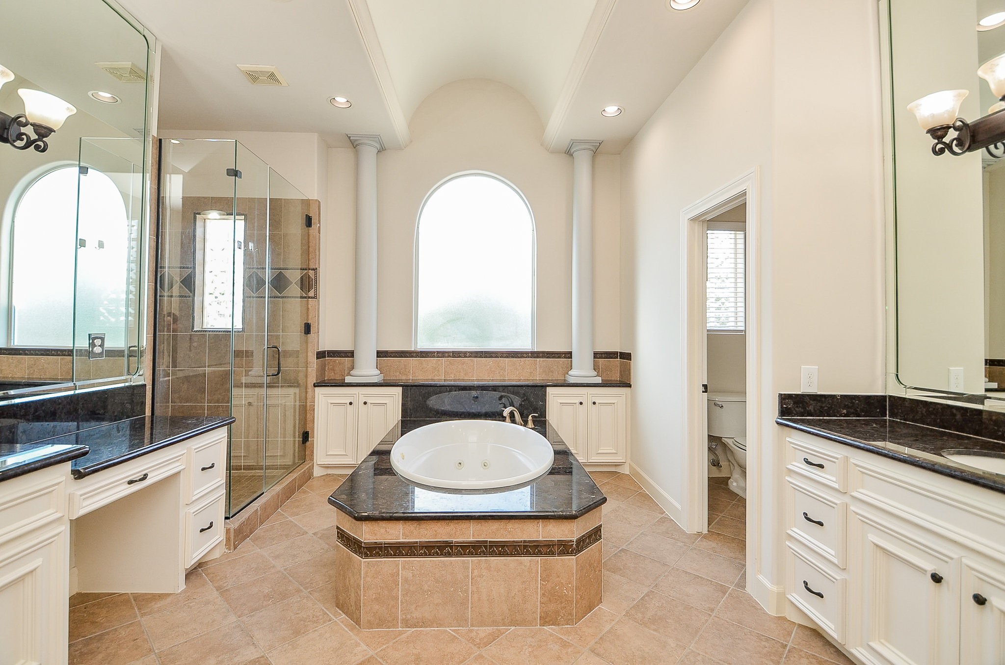 5512 Hidalgo Street Houston, TX 77056 - Photo 20 of 32 a spacious bathroom with a granite countertop toilet sink and mirror