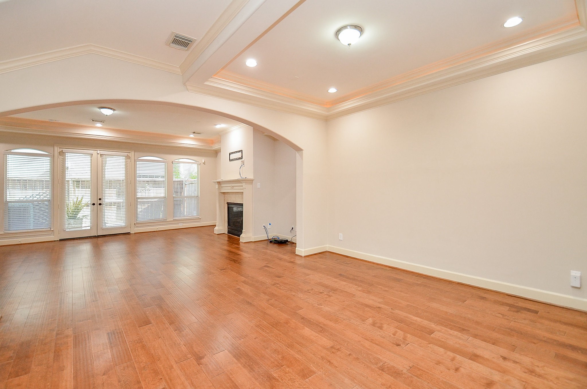 5512 Hidalgo Street Houston, TX 77056 - Photo 6 of 32 an empty room with wooden floor and windows