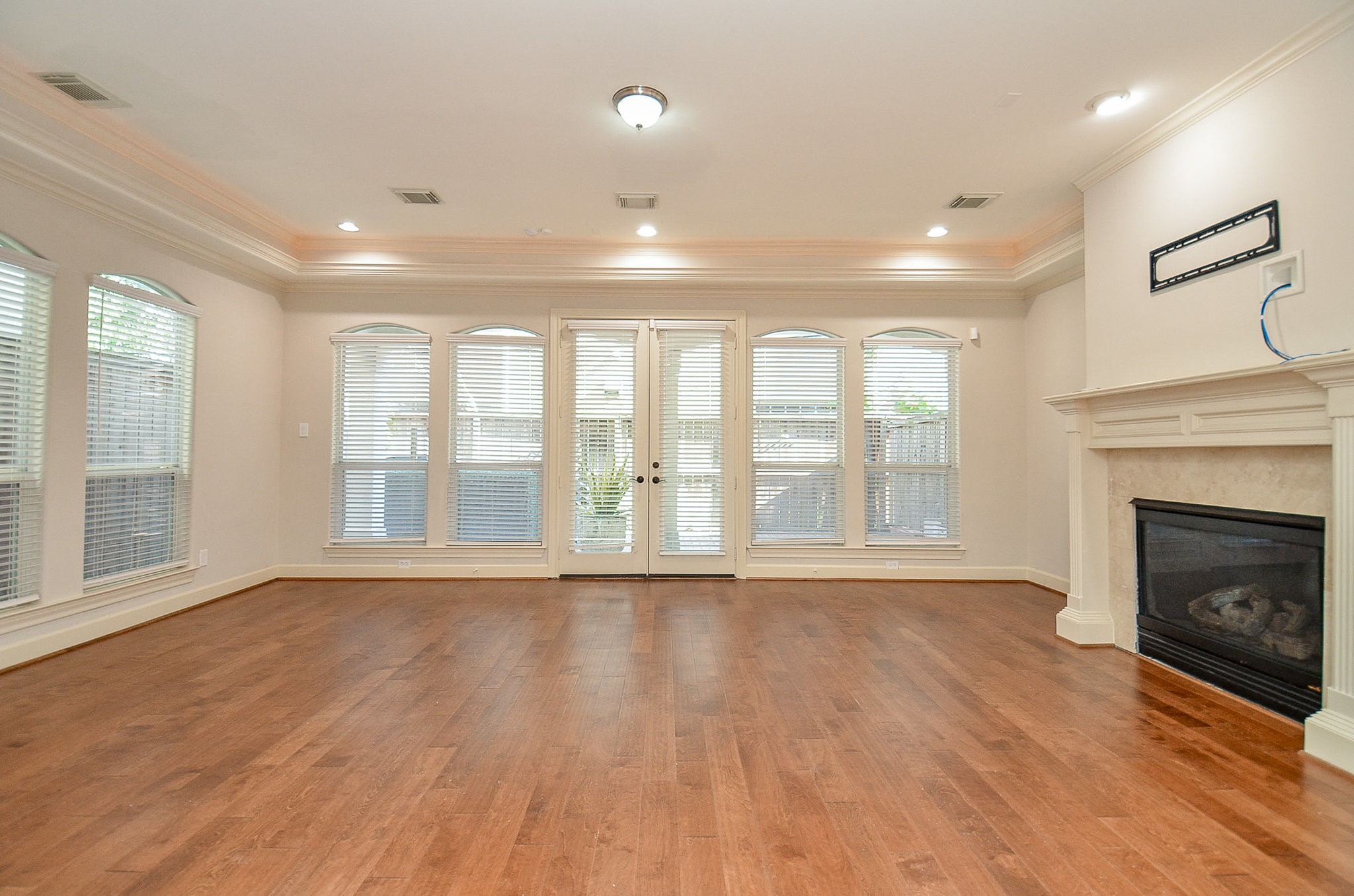 5512 Hidalgo Street Houston, TX 77056 - Photo 7 of 32 a view of an empty room with a fireplace and a window