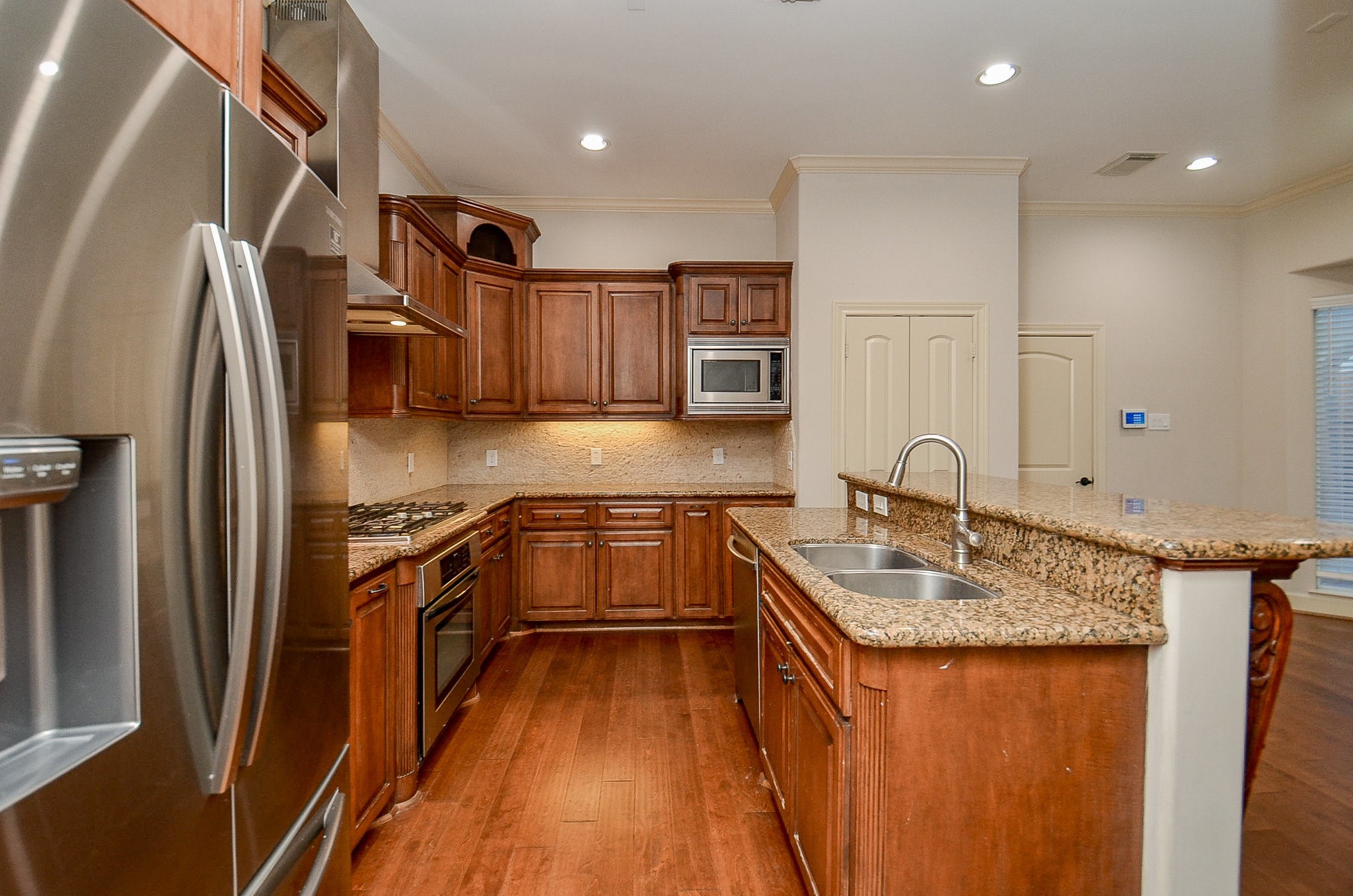 5512 Hidalgo Street Houston, TX 77056 - Photo 10 of 32 a kitchen with stainless steel appliances granite countertop a sink stove and refrigerator