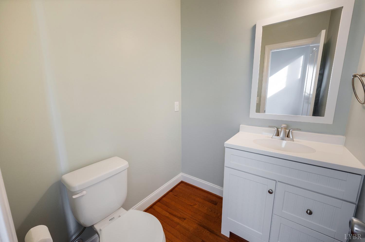 4802 Old Boonsboro Road Lynchburg, VA 24503 - Photo 20 of 57 a bathroom with a toilet sink vanity and mirror