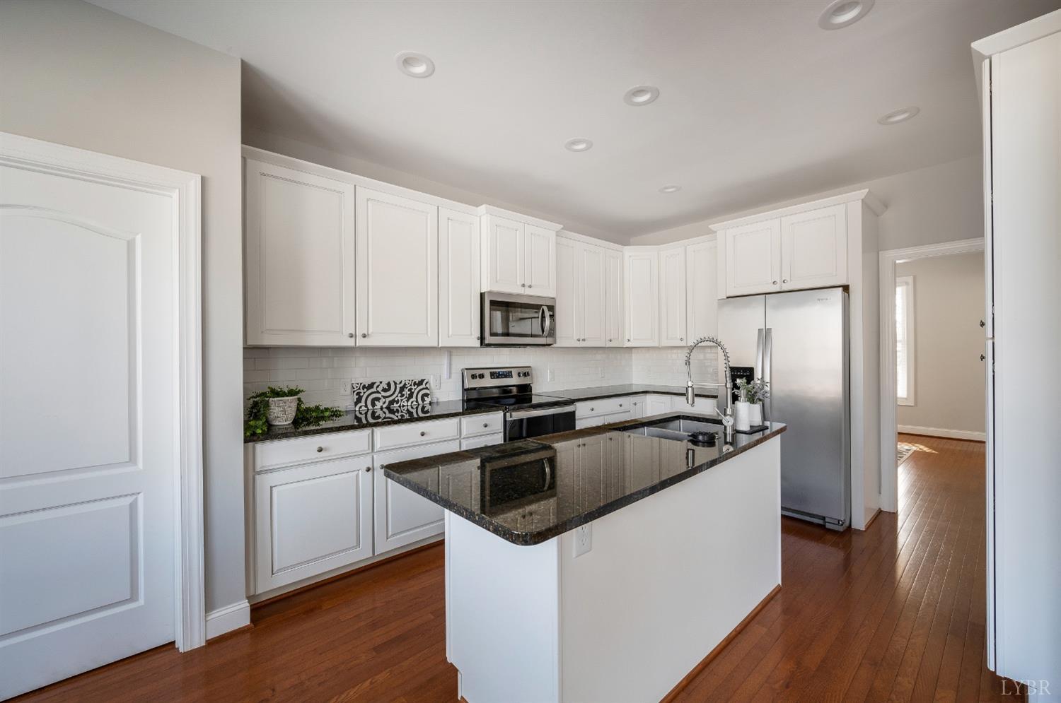 4802 Old Boonsboro Road Lynchburg, VA 24503 - Photo 23 of 57 a kitchen with white cabinets and stainless steel appliances
