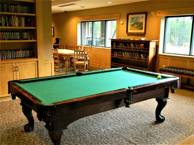 a living room with a couch and a book shelf