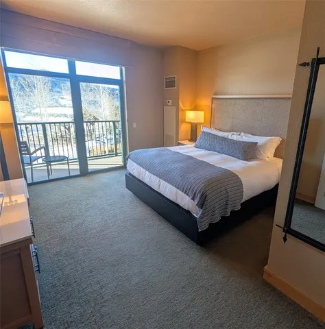 a bedroom with a bed and lamp