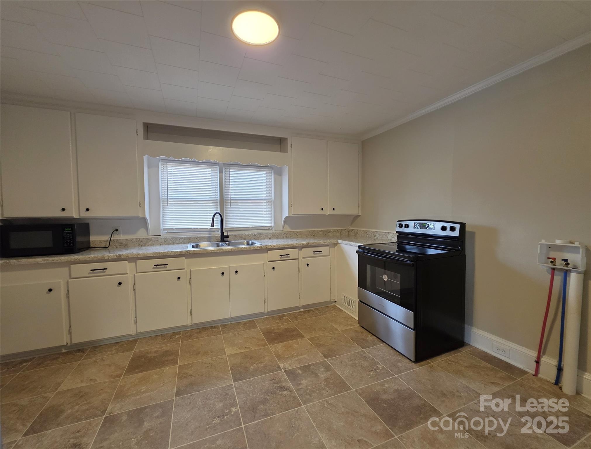 110 West 22nd Street Kannapolis, NC 28081 - Photo 5 of 15 a kitchen with a cabinets and window