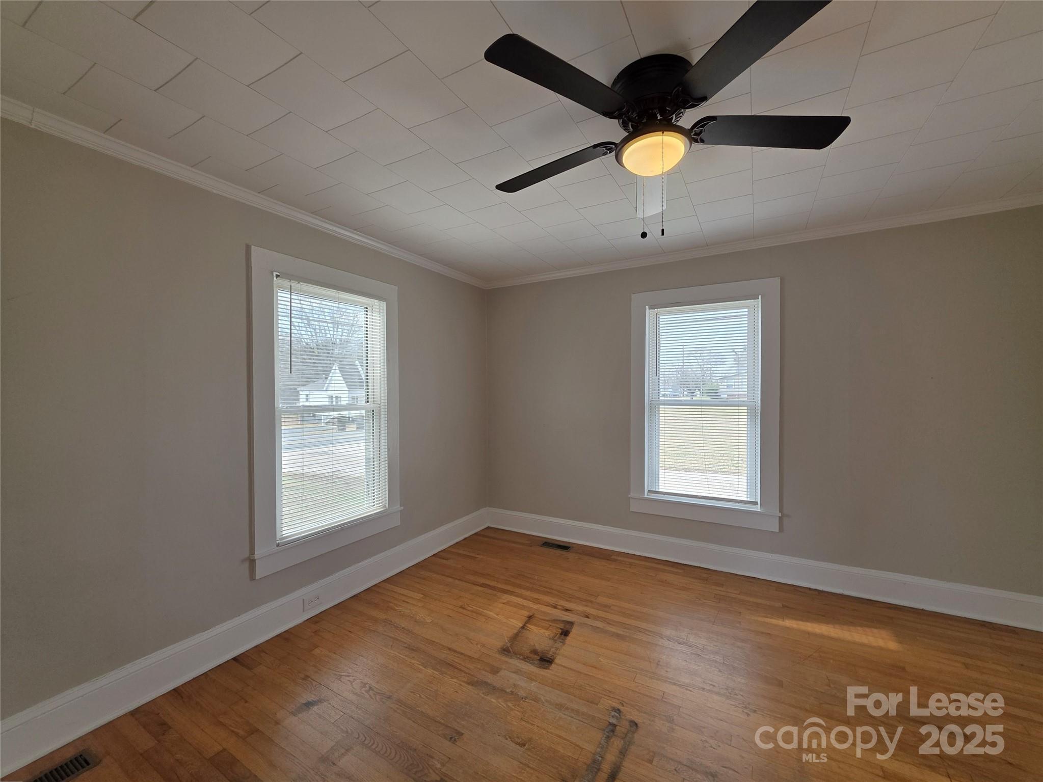 110 West 22nd Street Kannapolis, NC 28081 - Photo 6 of 15 an empty room with wooden floor and windows
