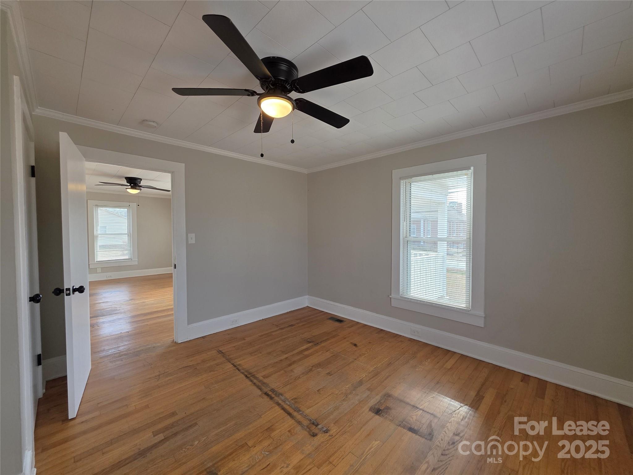 110 West 22nd Street Kannapolis, NC 28081 - Photo 7 of 15 an empty room with wooden floor fan and windows