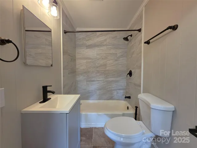 a bathroom with a toilet a sink and shower