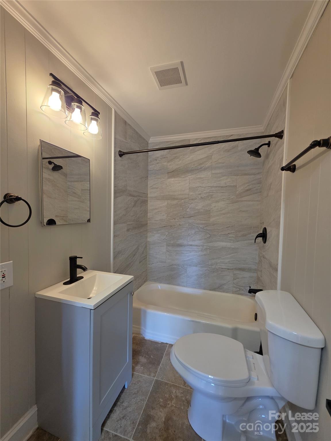 110 West 22nd Street Kannapolis, NC 28081 - Photo 9 of 15 a bathroom with a sink a toilet a mirror a bathtub and shower