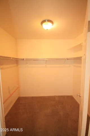 a bathroom with a granite countertop toilet and a sink