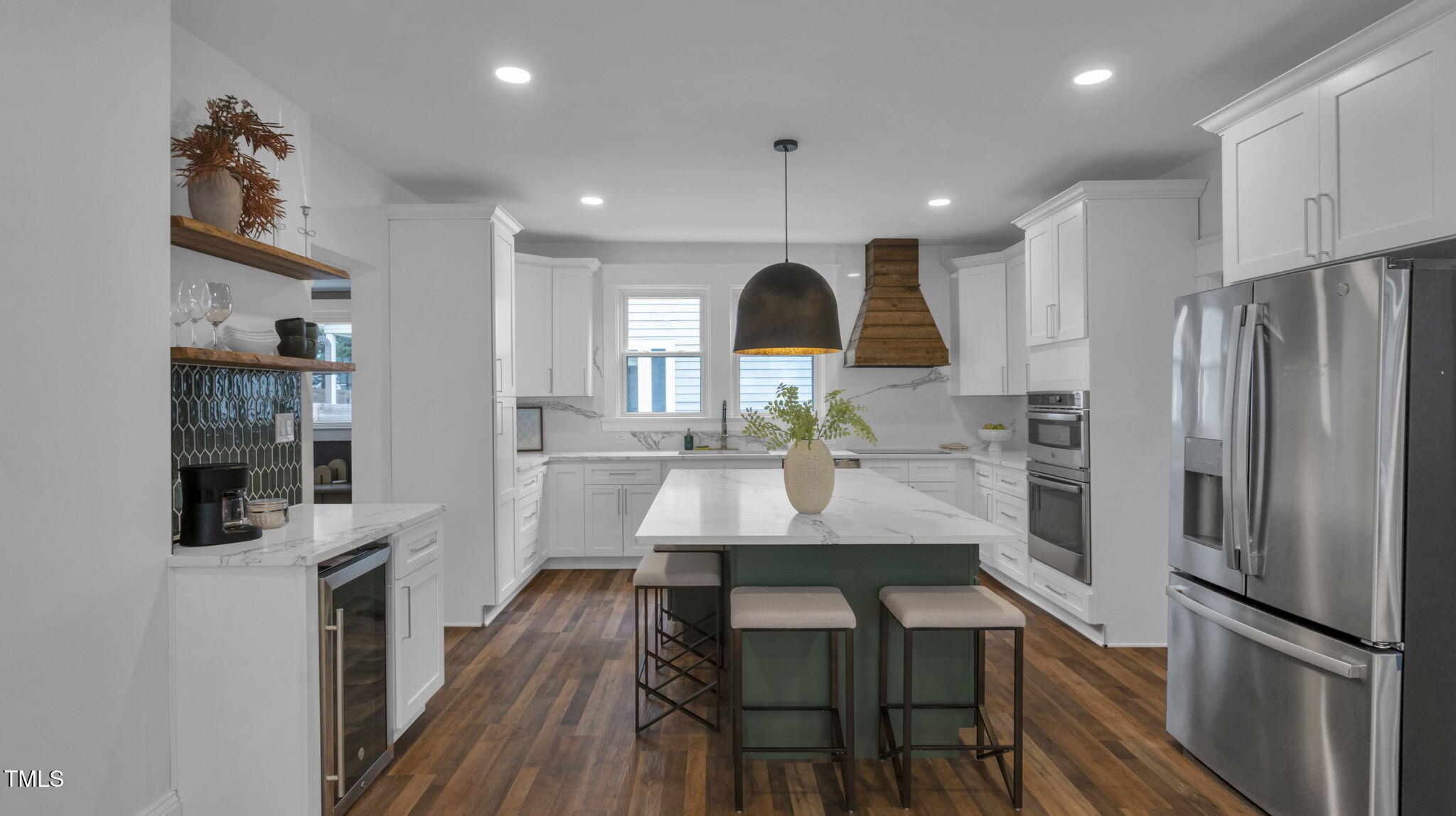 1307 Wake Forest Road Raleigh, NC 27604 - Photo 13 of 51 a kitchen with kitchen island stainless steel appliances a refrigerator a sink and wooden cabinets